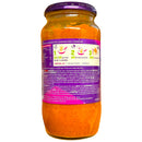 Jar of orange sauce with a purple label on a white background